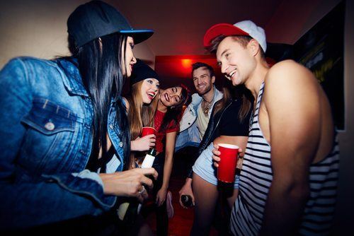 Young adults drinking at a house party
